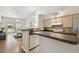 Modern kitchen featuring an open design, stainless steel appliances, and a breakfast bar overlooking the living area at 3638 Trafalgar Way # 103, Palm Harbor, FL 34685