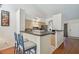 Open kitchen with bar seating, stainless steel refrigerator, and views to the living area at 3638 Trafalgar Way # 103, Palm Harbor, FL 34685