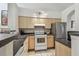 Efficient kitchen with modern appliances and ample cabinet space, perfect for cooking and entertaining at 3638 Trafalgar Way # 103, Palm Harbor, FL 34685
