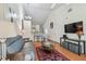 Bright living room with high ceilings and a view of the open kitchen and dining area at 3638 Trafalgar Way # 103, Palm Harbor, FL 34685