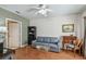 Living room with blue sofa, piano, and door to another room at 3638 Trafalgar Way # 103, Palm Harbor, FL 34685