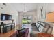 Living room featuring sliding doors to the patio and backyard views at 3638 Trafalgar Way # 103, Palm Harbor, FL 34685