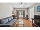 Inviting living room with a sofa, piano, and large window letting in natural light at 3638 Trafalgar Way # 103, Palm Harbor, FL 34685