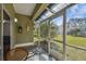 Relaxing screened-in patio with outdoor seating and views of the lush backyard at 3638 Trafalgar Way # 103, Palm Harbor, FL 34685