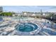 Sparkling community pool and hot tub surrounded by a paved sundeck at 3638 Trafalgar Way # 103, Palm Harbor, FL 34685