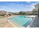 Inviting community pool with a paved deck, lounge chairs, and well-maintained landscaping at 3638 Trafalgar Way # 103, Palm Harbor, FL 34685