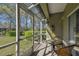 Screened-in patio with outdoor seating overlooking a lush lawn and landscaping at 3638 Trafalgar Way # 103, Palm Harbor, FL 34685