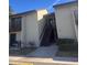 Exterior front view of condo unit with stairs leading to a second-story entrance at 4215 E Bay Dr # 1701B, Clearwater, FL 33764