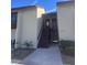 Exterior front view of condo unit with stairs leading to a second-story entrance at 4215 E Bay Dr # 1701B, Clearwater, FL 33764