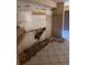 Kitchen in need of repair showing tile flooring and wall damage at 4215 E Bay Dr # 1701B, Clearwater, FL 33764