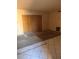 Living room needing repair, showcasing tile flooring and boarded closet space at 4215 E Bay Dr # 1701B, Clearwater, FL 33764