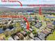 Aerial view of neighborhood near golf course, with lake view in the distance at 4410 Sawgrass Dr, Palm Harbor, FL 34685