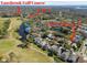 Aerial view of community featuring golf course, YMCA and water features at 4410 Sawgrass Dr, Palm Harbor, FL 34685