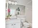 Stylish bathroom with a modern vanity, granite countertop, vessel sink, and an expansive mirror with accent lighting at 4410 Sawgrass Dr, Palm Harbor, FL 34685