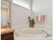 Bathroom features a soaking tub beneath a frosted window at 4410 Sawgrass Dr, Palm Harbor, FL 34685