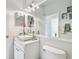 Bright bathroom with a vessel sink, stylish faucet, and white cabinets providing a fresh and modern aesthetic at 4410 Sawgrass Dr, Palm Harbor, FL 34685