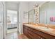 Bright bathroom features a dual sink vanity and ceramic tile flooring at 4410 Sawgrass Dr, Palm Harbor, FL 34685