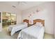 bedroom featuring two twin beds and cheerful butterfly wall decor at 4410 Sawgrass Dr, Palm Harbor, FL 34685