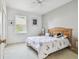Bright bedroom with a large window, modern decor, and a ceiling fan at 4410 Sawgrass Dr, Palm Harbor, FL 34685