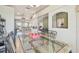 Bright dining room with a glass table, ornate metal chairs, and views into the home's open floorplan at 4410 Sawgrass Dr, Palm Harbor, FL 34685