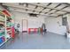Spacious two-car garage with organized shelving, epoxy floor, and ample room for storage and projects at 4410 Sawgrass Dr, Palm Harbor, FL 34685