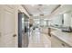 Bright kitchen featuring stainless steel appliances, white cabinets, and tile flooring at 4410 Sawgrass Dr, Palm Harbor, FL 34685