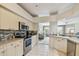 Bright kitchen with modern appliances, including stainless steel oven and microwave, with backyard views at 4410 Sawgrass Dr, Palm Harbor, FL 34685