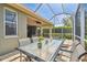 Screened-in lanai features a dining area, patio, and pool with beautiful views of the surrounding greenery at 4410 Sawgrass Dr, Palm Harbor, FL 34685