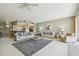 Spacious living room with neutral tones, ceiling fan, and comfortable seating arrangement at 4410 Sawgrass Dr, Palm Harbor, FL 34685