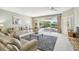 Bright living room with neutral walls, sliding glass doors to a patio with a spa, and a ceiling fan at 4410 Sawgrass Dr, Palm Harbor, FL 34685