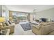 Inviting living room with comfortable seating, a ceiling fan, and sliding glass doors at 4410 Sawgrass Dr, Palm Harbor, FL 34685