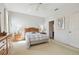 Bright primary bedroom with neutral tones, a ceiling fan, and ample closet space at 4410 Sawgrass Dr, Palm Harbor, FL 34685