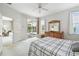 Light-filled main bedroom with patio access and adjoining seating area at 4410 Sawgrass Dr, Palm Harbor, FL 34685