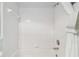 Bright and clean tiled shower and tub combination with a shower curtain and towel rack at 4410 Sawgrass Dr, Palm Harbor, FL 34685