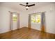 Sunlit bedroom with hardwood floors, large windows, and contemporary striped curtains at 4430 11Th N Ave, St Petersburg, FL 33713