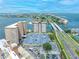 Aerial view of waterfront condo buildings, a bridge, and lush surroundings at 5220 Brittany S Dr # 1409, St Petersburg, FL 33715