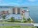 Stunning aerial view of a waterfront condo building with on-site parking near a beautiful bay at 5220 Brittany S Dr # 1409, St Petersburg, FL 33715
