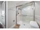 Modern bathroom features a glass-enclosed shower with tiled walls and safety bars at 5220 Brittany S Dr # 1409, St Petersburg, FL 33715