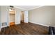 Spacious bedroom with wood floors, a closet, and white doors at 5220 Brittany S Dr # 1409, St Petersburg, FL 33715