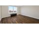 Bright bedroom featuring wood floors, a large window with a city view, and a tufted leather bench at 5220 Brittany S Dr # 1409, St Petersburg, FL 33715