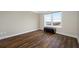 Bright bedroom featuring wood floors, a large window with a water view, and a tufted leather bench at 5220 Brittany S Dr # 1409, St Petersburg, FL 33715