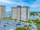 Exterior view of a high-rise condominium featuring a large parking lot and waterfront access at 5220 Brittany S Dr # 1409, St Petersburg, FL 33715