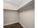A walk-in closet with ample shelving and modern wood-like flooring at 5220 Brittany S Dr # 1409, St Petersburg, FL 33715