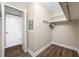A closet featuring storage shelves, clothing racks and modern wood-like flooring at 5220 Brittany S Dr # 1409, St Petersburg, FL 33715
