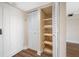Hallway closet with bifold doors and shelving at 5220 Brittany S Dr # 1409, St Petersburg, FL 33715