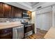Spacious kitchen with stainless steel appliances, dark cabinets, and a view into the living area at 5220 Brittany S Dr # 1409, St Petersburg, FL 33715