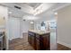 Bright kitchen with an island, white cabinets, and an opening to the living area at 5220 Brittany S Dr # 1409, St Petersburg, FL 33715