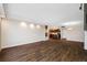 An open concept living room with wood floors, recessed lighting and a view into the kitchen at 5220 Brittany S Dr # 1409, St Petersburg, FL 33715