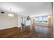Spacious living room with wood floors, stone accent wall, and balcony access at 5220 Brittany S Dr # 1409, St Petersburg, FL 33715