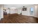 Living room with hardwood floors, open doorway to a balcony and a view to the kitchen at 5220 Brittany S Dr # 1409, St Petersburg, FL 33715
